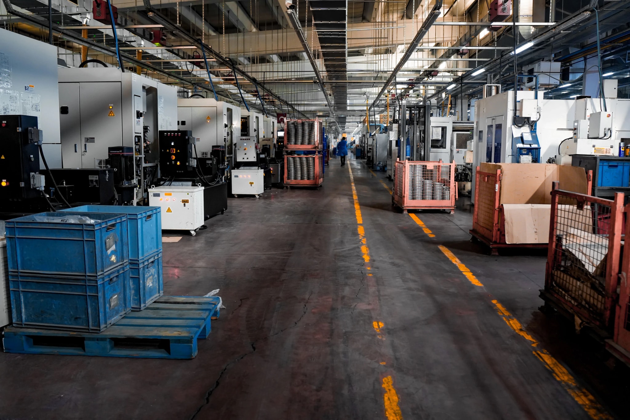 Operators on a production floor working beside a running line.