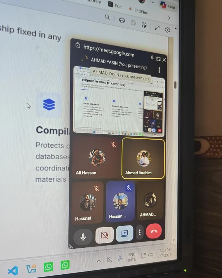 A Google Meet call on the office monitor: a screen being presented, with five of the team on camera beside it.