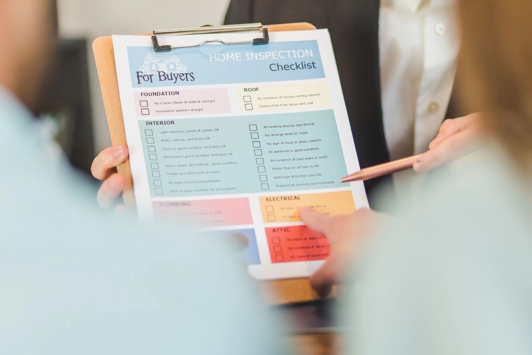 Two people going through a checklist on a clipboard.